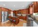 Spacious kitchen featuring wooden cabinets, stainless steel appliances, and a granite island with seating at 3086 Frazier Walk, Decatur, GA 30033