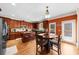 An open-concept kitchen shows a wooden dining table and chairs for Gathering meals, alongside wood cabinets at 3086 Frazier Walk, Decatur, GA 30033