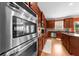 Modern kitchen featuring built-in stainless steel appliances, wooden cabinets and a large breakfast bar at 3086 Frazier Walk, Decatur, GA 30033