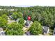 An aerial view of the property surrounded by lush greenery in a suburban setting at 3454 Carriage Chase Rd, Atlanta, GA 30349
