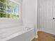 Inviting bathtub and shower with large window to view greenery in this bathroom at 3454 Carriage Chase Rd, Atlanta, GA 30349