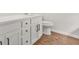 Modern bathroom with stylish white cabinets, dark hardware, and updated toilet at 3454 Carriage Chase Rd, Atlanta, GA 30349