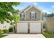 Charming two-story home featuring a two-car garage and neat landscaping, and inviting curb appeal at 3454 Carriage Chase Rd, Atlanta, GA 30349