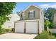 Charming two-story home featuring a two-car garage and neat landscaping, with driveway at 3454 Carriage Chase Rd, Atlanta, GA 30349