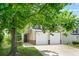 Charming two-story home featuring a two-car garage with large tree in the front yard at 3454 Carriage Chase Rd, Atlanta, GA 30349