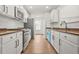 Modern kitchen featuring stainless steel appliances, white cabinets, and light countertops at 3454 Carriage Chase Rd, Atlanta, GA 30349