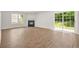 Well-lit living room features hardwood floors, a cozy fireplace, and a sliding glass door at 3454 Carriage Chase Rd, Atlanta, GA 30349