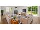Inviting living room with modern decor, fireplace, large windows, and sliding glass door to the backyard at 3454 Carriage Chase Rd, Atlanta, GA 30349
