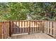 Wooden back deck with natural wood fencing and views of mature trees at 5560 Kingsport Ne Dr # 27, Atlanta, GA 30342