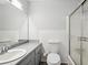 Bathroom featuring a toilet and shower/tub combo with a sliding glass door and neutral paint at 5560 Kingsport Ne Dr # 27, Atlanta, GA 30342