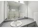 Bathroom featuring a gray vanity with a white sink, a large mirror, and a shower/tub combo at 5560 Kingsport Ne Dr # 27, Atlanta, GA 30342