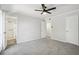 Spacious bedroom featuring plush carpet, lighted ceiling fan and ensuite bathroom access at 5560 Kingsport Ne Dr # 27, Atlanta, GA 30342