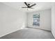 Bedroom with neutral colored walls, carpet, and a ceiling fan with natural light from a window at 5560 Kingsport Ne Dr # 27, Atlanta, GA 30342