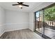 Dining area with ceiling fan, wood-look flooring, patio access, and trim at 5560 Kingsport Ne Dr # 27, Atlanta, GA 30342