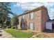 Brick apartment building with green shutters and trim surrounded by mature trees and landscaping at 5560 Kingsport Ne Dr # 27, Atlanta, GA 30342
