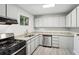 Bright kitchen featuring stainless steel appliances, granite counters, and crisp white cabinetry at 5560 Kingsport Ne Dr # 27, Atlanta, GA 30342
