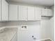 Functional laundry room with upper cabinets and granite countertop at 5560 Kingsport Ne Dr # 27, Atlanta, GA 30342