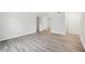 Neutral living room with wood-look flooring, base molding, and light gray walls at 5560 Kingsport Ne Dr # 27, Atlanta, GA 30342