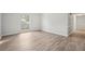 Bright living room featuring wood-look flooring and neutral walls with views of exterior at 5560 Kingsport Ne Dr # 27, Atlanta, GA 30342