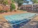 Community pool with a safety cover in place near attractive brick townhomes in a residential neighborhood at 5560 Kingsport Ne Dr # 27, Atlanta, GA 30342