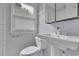 Cozy bathroom featuring a pedestal sink, white tiled walls, and natural light at 1585 Melanie Ct, Decatur, GA 30032