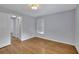 Bedroom showcasing neutral walls, wood floors and a window with bright natural light at 1585 Melanie Ct, Decatur, GA 30032