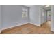 Bright bedroom with natural light, light gray walls, and wood-look floors at 1585 Melanie Ct, Decatur, GA 30032