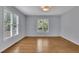 Bright bedroom with hardwood floors, neutral paint, and natural light from two large windows at 1585 Melanie Ct, Decatur, GA 30032
