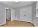 Bedroom featuring neutral walls, wood floors and a double door closet for ample storage at 1585 Melanie Ct, Decatur, GA 30032