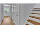 Hallway with wood floors, closet, and stairs with decorative wallpaper accent at 1585 Melanie Ct, Decatur, GA 30032