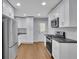 Modern kitchen with stainless steel appliances, white cabinets, and plenty of counter space at 1585 Melanie Ct, Decatur, GA 30032