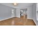 Open-concept living room with hardwood floors leading to the kitchen and an exterior door at 1585 Melanie Ct, Decatur, GA 30032