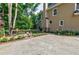 Backyard featuring a patio area, lush landscaping, and a well-maintained lawn at 3620 Chartwell Dr, Suwanee, GA 30024