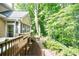 Backyard featuring a deck, stairs, landscaping, trees, and mulch at 3620 Chartwell Dr, Suwanee, GA 30024