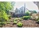 Well-maintained backyard with mature trees and flourishing plants, creating a serene outdoor retreat at 3620 Chartwell Dr, Suwanee, GA 30024