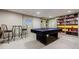 Carpeted basement featuring a pool table, seating, bar stools, and wall decor at 3620 Chartwell Dr, Suwanee, GA 30024