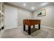 Finished basement including a foosball table, neutral walls, and carpeted floors at 3620 Chartwell Dr, Suwanee, GA 30024