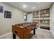 Finished basement including a foosball table, shelving, neutral walls, and carpeted floors at 3620 Chartwell Dr, Suwanee, GA 30024