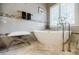 Bright, updated bathroom with a soaking tub, stylish fixtures, and stone tile flooring at 3620 Chartwell Dr, Suwanee, GA 30024