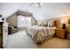 Comfortable bedroom featuring carpet, chair, lamps, stylish furniture, and natural light from window at 3620 Chartwell Dr, Suwanee, GA 30024
