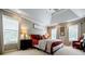 Comfortable primary bedroom with tray ceilings, natural light, and neutral color palette at 3620 Chartwell Dr, Suwanee, GA 30024