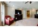 Well-lit bedroom featuring a dresser with a TV and doorway to the bathroom at 3620 Chartwell Dr, Suwanee, GA 30024