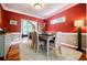 Warm dining room with red walls, wainscoting, and a cozy ambiance for memorable meals at 3620 Chartwell Dr, Suwanee, GA 30024