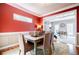 Charming dining room with red walls, wainscoting, and a view into the adjacent office, perfect for Gathering gatherings at 3620 Chartwell Dr, Suwanee, GA 30024