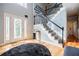 Elegant foyer with hardwood floors, staircase, and decorative accents at 3620 Chartwell Dr, Suwanee, GA 30024