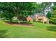 Lovely brick home with a spacious, well-maintained lawn and mature trees at 3620 Chartwell Dr, Suwanee, GA 30024
