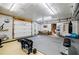 Spacious garage featuring gym equipment, rubber floors, a garage door, and exposed duct work at 3620 Chartwell Dr, Suwanee, GA 30024