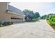 Side of house with driveway and three-car garage at 3620 Chartwell Dr, Suwanee, GA 30024