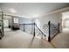 Bright, open hallway with carpeted floors, gray walls, and decorative wrought iron railing at 3620 Chartwell Dr, Suwanee, GA 30024