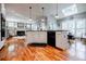 Open-concept kitchen with stainless steel appliances, center island, and seamless flow to the living area at 3620 Chartwell Dr, Suwanee, GA 30024